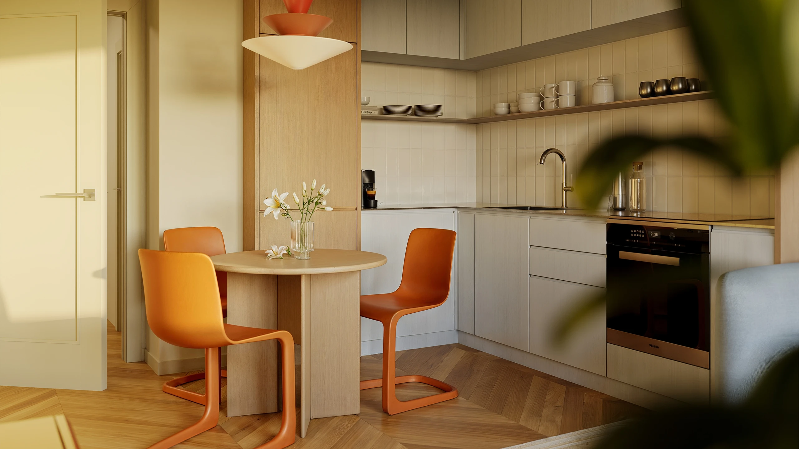 Dining nook with a round table and orange chairs